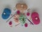 Colored balls of crochet thread, scissors and a needle on a white background