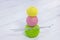 Colored balls for knitting and knitting needles lie on a white wooden background. copyspace. creation. green, yellow and pink thre