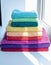 Colored bath towels lie on the window