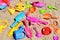 Colored beach toys in sand background, kids have fun at the seaside