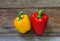 Colored bell peppers on wooden