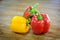 Colored bell peppers on wooden table