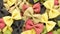 Colored bow tie pasta. Closeup multiple farfalle.