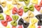 Colored bow tie pasta. Closeup multiple farfalle on white background