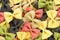 Colored bow tie pasta. Closeup multiple farfalle on white background