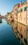 Colored buildings reflection of Vena canal in Chioggia - Italy