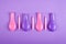 Colored candles and air balloons composition on purple background, party and celebration decoration