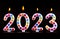 Colored candles write numbers flame Happy new year 2023