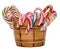 Colored candy sticks and Christmas lollipops in a brown vase, isolated, white background.