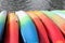 Colored canoes near the water on the pier