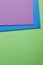 Colored carboards background in green blue purple tone. Copy spa