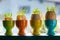 Colored ceramic eggcups with egg shells