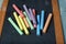 Colored chalks on the blackboard