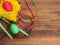 Colored chicken egg on background of bright yellow straw, colored ribbon and old wooden table. The view from the top.