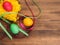 Colored chicken egg on background of bright yellow straw, colored ribbon and old wooden table. The view from the top.