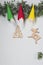 Colored Christmas felt dwarfs and wooden toys.Homemade Christmas craft decorations on needles of  tree.