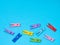 Colored clothespins or clothes peg collection on blue background