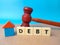 Colored cube,gavel and toys word DEBT