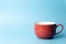 Colored cup on an empty colored background, minimal concept background. Home cookware and morning idea