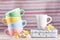 Colored cups with a pitcher and daffodils vintage retro