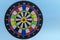 Colored dartboard, on a blue background foreground. Darts without darts. Successful strategy concept