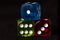 colored dice black background