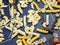 Colored different types of Italian pasta on a dark background. food texture. flour products and food in cooking