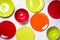 Colored dinnerware - red and green plates on light stone table.