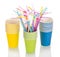 Colored disposable paper cups and straws isolated on white.