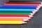 Colored drawing pencils on the wooden grey table. Colorful pencils in a variety of colors. Back to school concept.