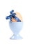 Colored easter egg with blue polka-dotted ribbon