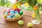 Colored easter eggs in basket and flowers