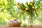 Colored easter eggs in basket and flowers