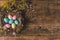 Colored Easter eggs in a beautiful nest. Against the background of an old wooden board