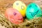 Colored Easter eggs with painted faces.