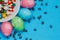 Colored easter eggs on a saucer on a blue background