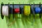 Colored electrical wires wrapped in reels in a stand on the wall