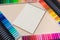 Colored felt-tip pens and a notebook on a beige background with a place for text top view. Bright banner for a