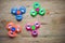 Colored fidget spinners stress relieving toy on wooden background