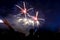 Colored firework background with free space for text. Colorful fireworks at night light up the sky with dazzling display