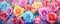 Colored flowers wallpaper top view.Rainbow roses wide banner