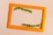 A colored frame decorated with green branches with catkins on a light background of the mine space. Flat Ley bright orange