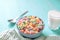 Colored fruit grain loops with a glass of milk on the table. breakfast concept