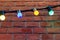 Colored garland on a brick wall. design stonewall brickwork