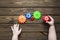 Colored gears, hands on a wooden background