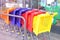 Colored grocery plastic carts for little shoppers stand one behind the other at the entrance to the grocery store, European