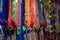 Colored handmade necklaces on sale in the street shops in Varanasi, India. For tourtists and pilgrims. Selective focus