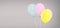 Colored helium balloons isolated on grey background, birthday concept