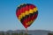 Colored hot hair balloon flying over italian apennines