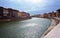 Colored houses on embankment of River Arno in Pisa, Tusc